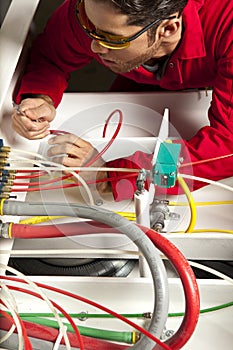 Technician inspecting colorful wiring circuit