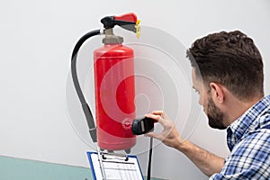 Technician Inspecting Fire Extinguisher