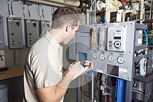 Technician inspecting heating system in boiler