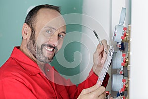 technician inspecting heating system in boiler room