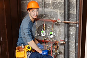 Technician inspecting heating system in boiler room