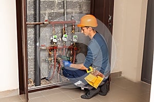 Technician inspecting heating system in boiler room