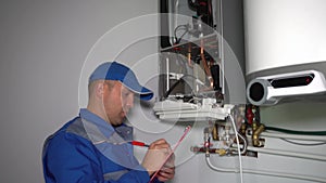 Technician inspector inspecting maintenance gas boiler heating system