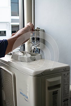 Technician install air conditioner outdoor unit