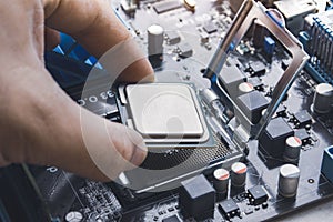 Technician install CPU processor chip in socket