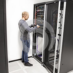 IT technician install network rack in datacenter