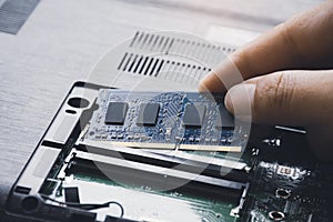 Technician install new RAM Random-access memory to memory slot