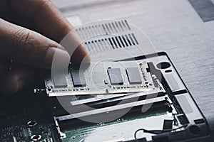 Technician install new RAM to memory slot