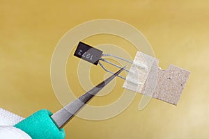 A technician install the new transistor in modern electronic device