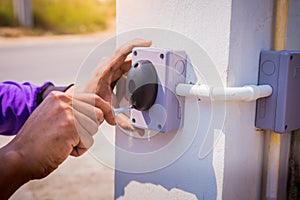 Technician installed and test motion sensor to control gate for motor automatic gate home security system