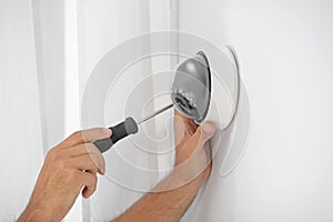 Technician installing camera on wall, closeup