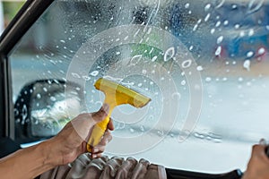Technician Installing car window tint. Car window tinting series. Car window tinting specialist install car film windscreen.