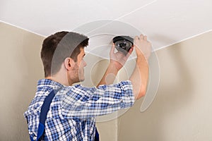 Technician Installing Surveillance Camera