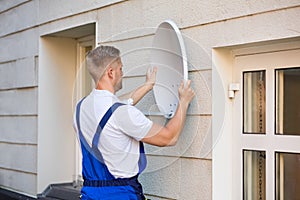 Technician Installing TV Satellite Dish