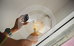 Technician installing wireless CCTV camera by screwed for home security system and installed w