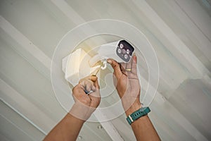 Technician installing wireless CCTV camera by screwed for home security system and installed w