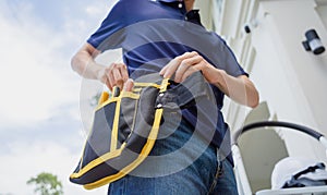 A technician installs a CCTV camera on the facade of a residential building.