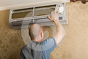 The technician installs a new air conditioner