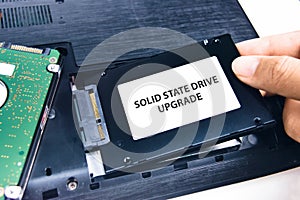 A technician installs a Solid State Drive SSD