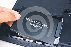 A technician installs a Solid State Drive SSD
