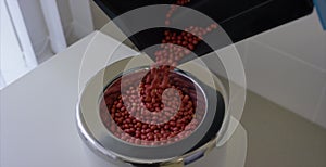 Technician In the laboratory tests the quality of grains and beans. Euipment to check the quality of the beans. testing