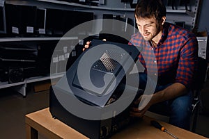 Technician looking at the broken system unit