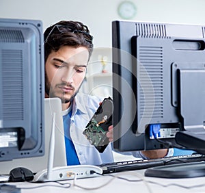 IT technician looking at IT equipment