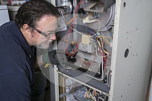 Technician Looking Over A Gas Furnace