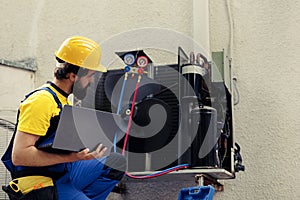 Technician looking for refrigerant leaks