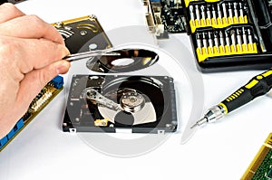 Technician makes a hard drive dissection, computer repair