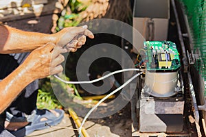 Technician man installing automatic electronic gate in the house.