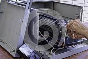 Technician man repair Evaporative fan