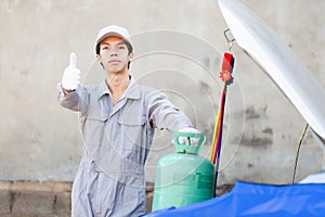 Technician man showing thumbs up, Repairman checks and fixed car air conditioning system refrigerant recharge, Car Air