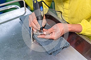 Technician marking numbeer of equipment with electric marking pen