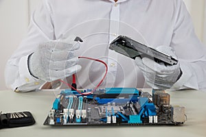 Technician With Motherboard And Harddisk