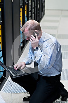 IT technician with network equipment and laptop