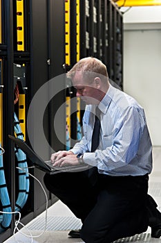 IT technician with network equipment and laptop