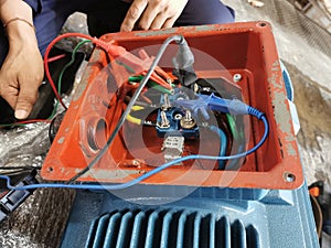 Technician open box of Electric motor for inspection and insulation test wireding, Corrective maintenance concept