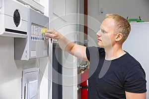 IT Technician Opening Fire Panel In Server Room