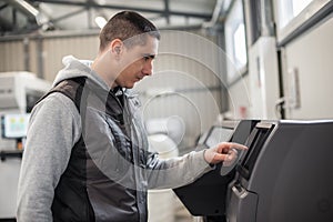 Technician operator checking status on touchscreen front display monitor station