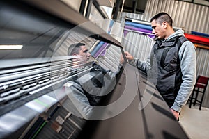 Technician operator checking status on touchscreen front display monitor station