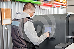 Technician operator checking status on touchscreen front display monitor station