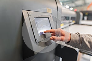 Technician operator checking status on touchscreen front display monitor station