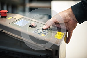 Technician operator checking status on touchscreen front display monitor station