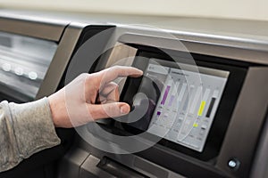 Technician operator checking status on touchscreen front display monitor station