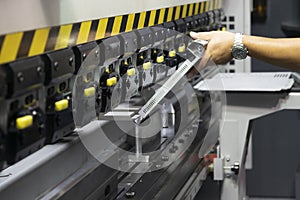 The technician operator use hydraulic bending machine.