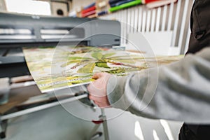 Technician operator works on large premium industrial printer plotter machine