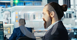 Technician optimizing energy supply in solar panel manufacturing plant