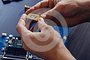 Technician plug in CPU microprocessor to computer motherboard
