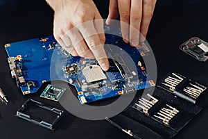 Technician plug in CPU microprocessor to computer motherboard